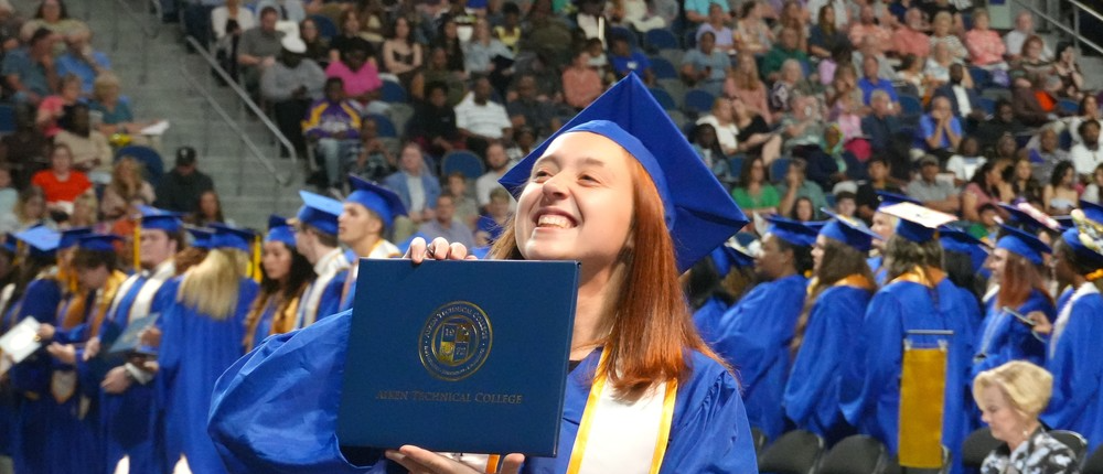 Midland Valley student showcases new diploma at graduation.