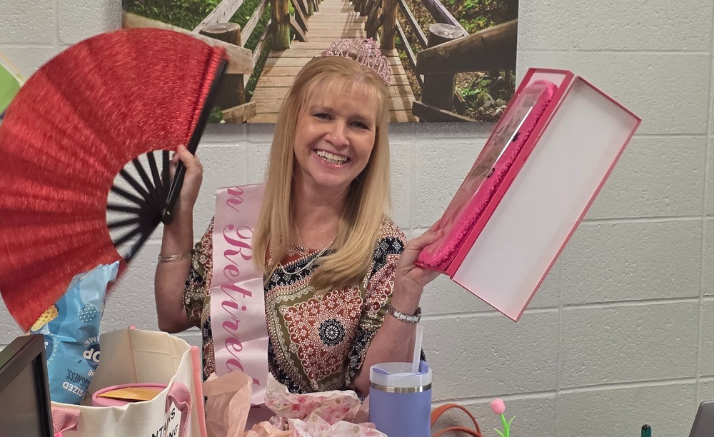 Woman holding fan and gift.