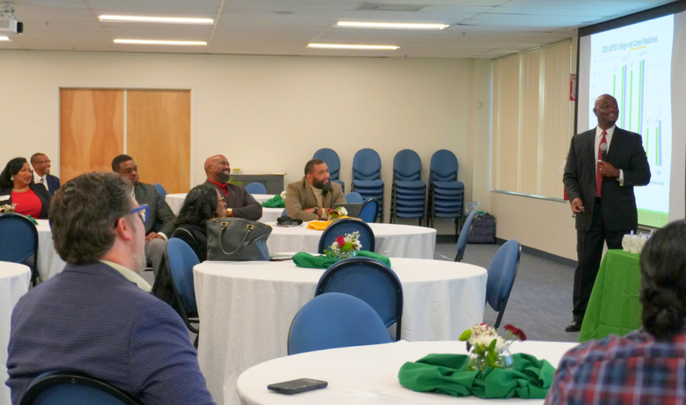 Superintendent Dr. Corey Murphy presenting year review.