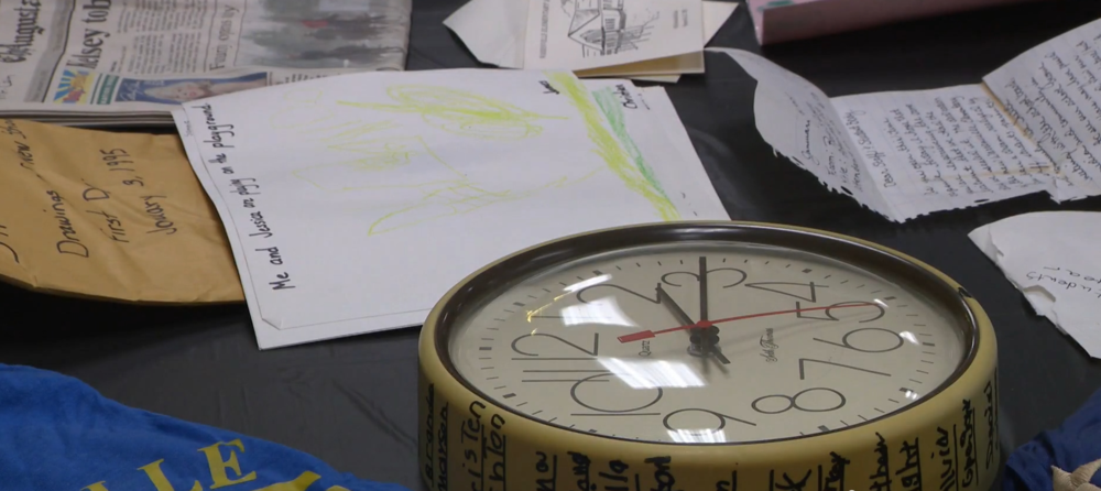 Items found in a time capsule from 1995. A newspaper, clock and letters from former students. 