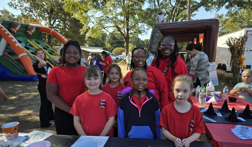Two adults and five children at a festival.