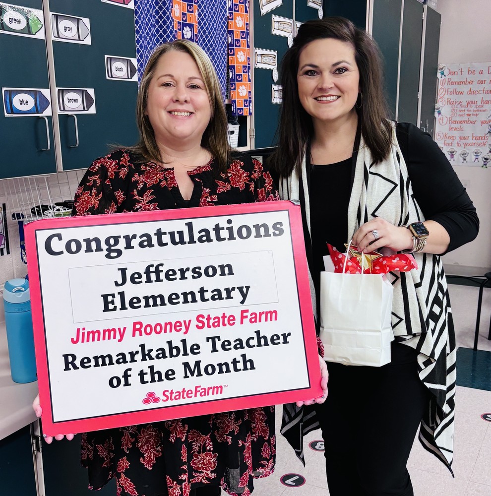 A teacher receives an award for teacher of the month.