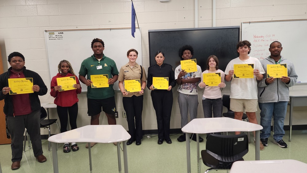 Students holding certificates and smiling