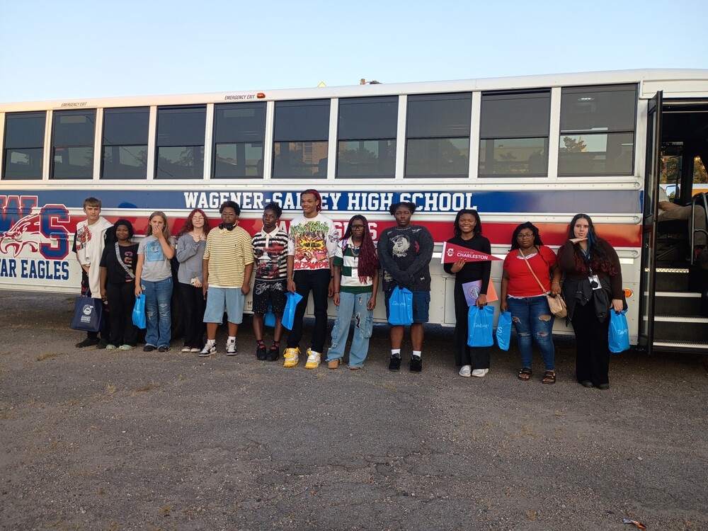 Students posing in front of the WSHS activity  bus