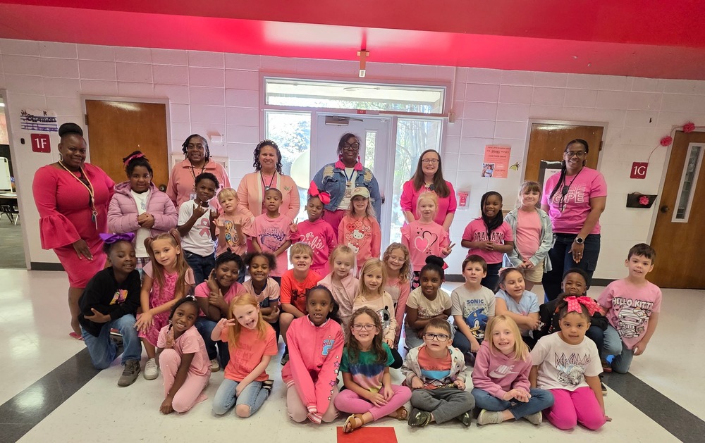 Group of students and staff wearing pink.