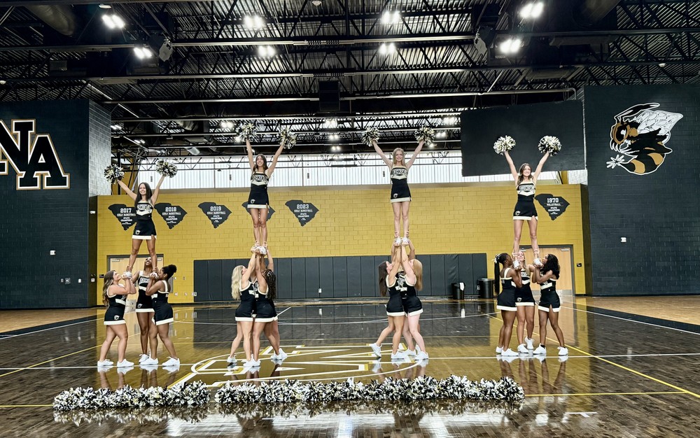 North Augusta High Cheerleaders practice in school gym.