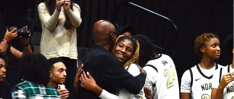 Al Young hugs a North Augusta basketball player.