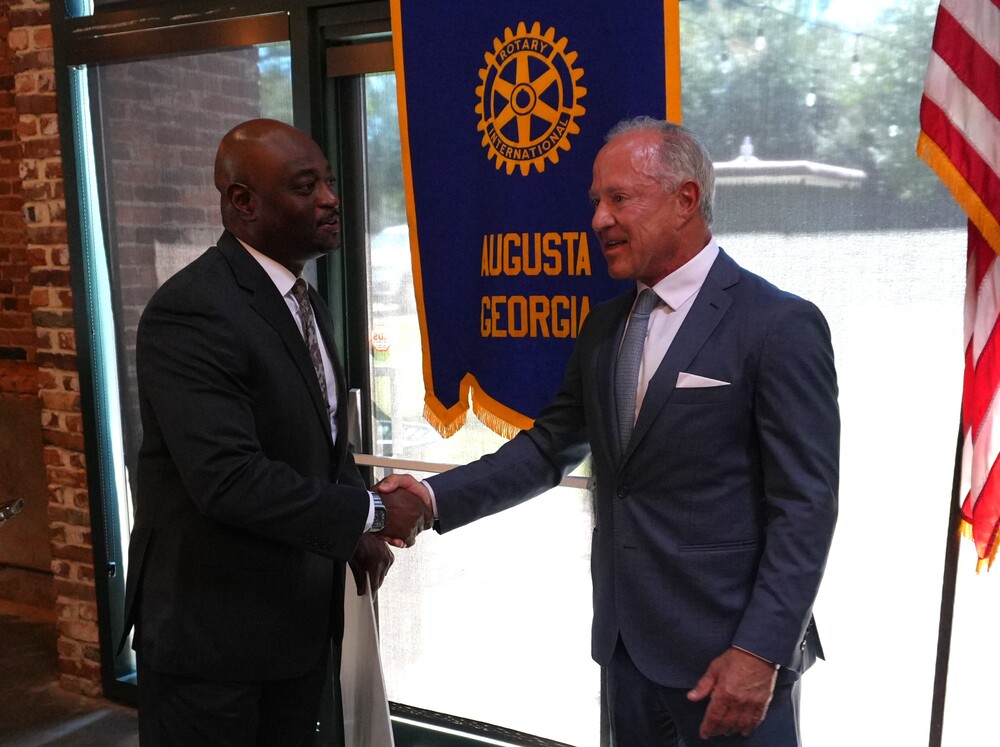 Aiken County Public Schools Superintendent Dr. Corey Murphy shakes hands with Rotary Augusta Club member.