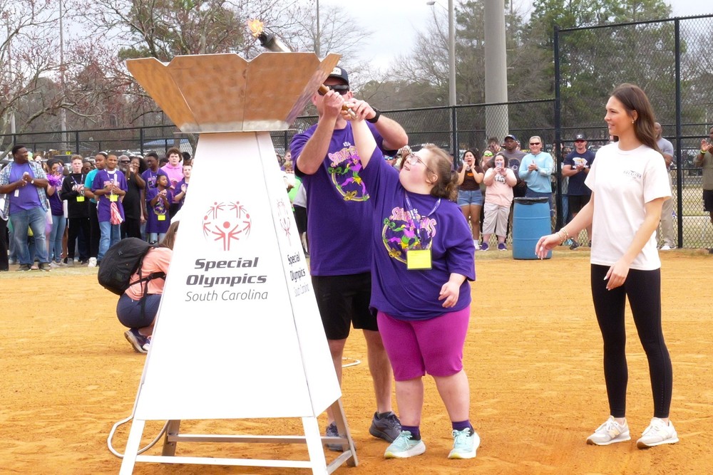 Student helps light Special Olympics torch during Area 15 event.