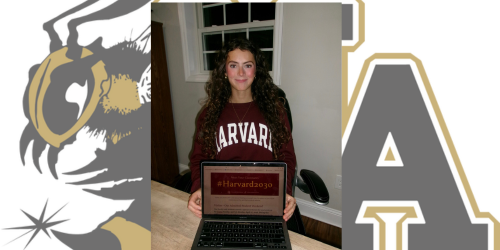 Girl with Harvard Shirt holding up computer showing Harvard Class of 2030!