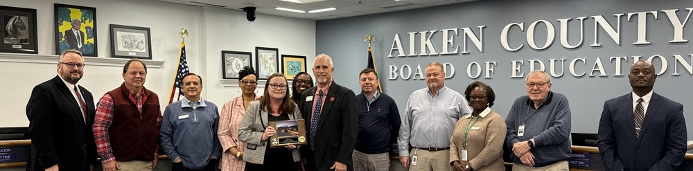 Aiken County Board of Education members are joined by Dr. Gary Senn and Kristie Brooks in receiving an administrative award