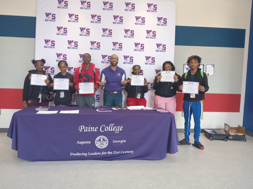 students holding their acceptance certificates