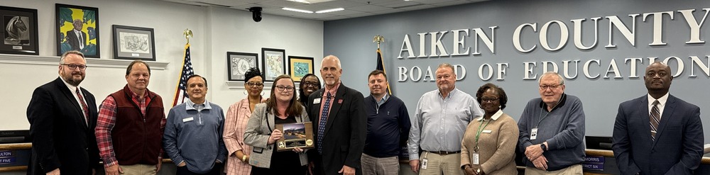 Aiken County Board of Education members are joined by Dr. Gary Senn and Kristie Brooks in receiving an administrative award
