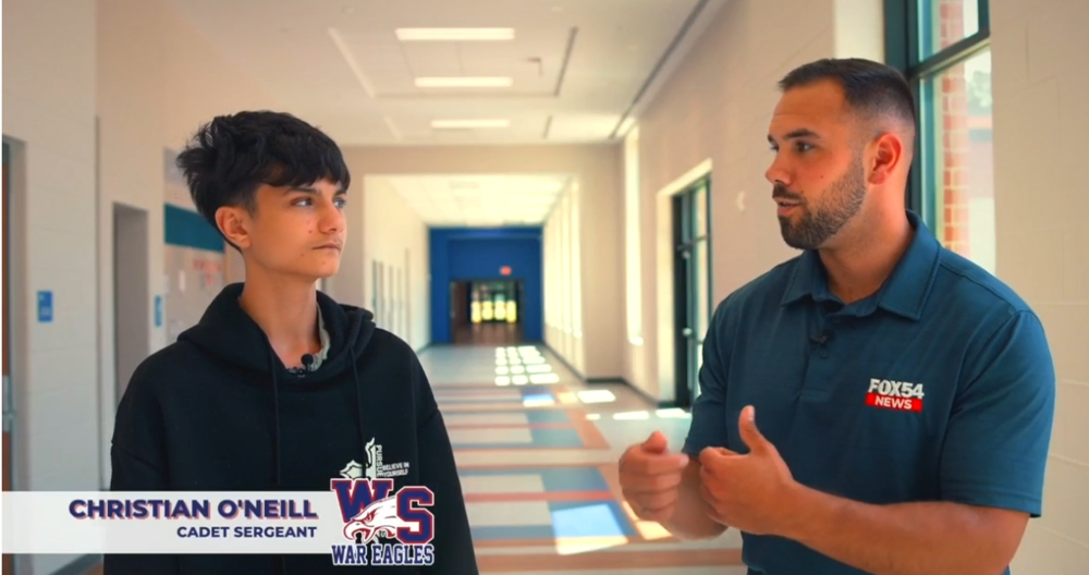 FOX 54 New Anchor, Roland Jackson interviewing Wagener-Salley High School Student Christian O'Neill in a hallway.