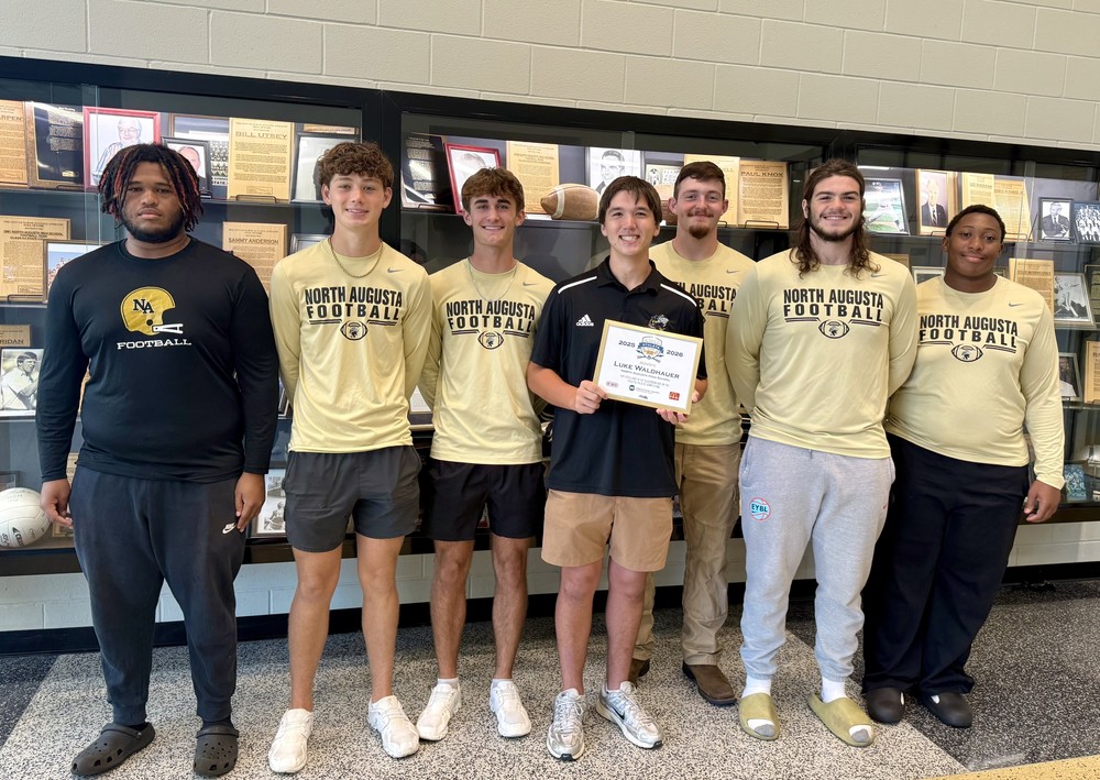 LUKE WALDHAUER OF NORTH AUGUSTA HIGH HONORED AS SCHOLAR ATHLETE posing with his teammates.