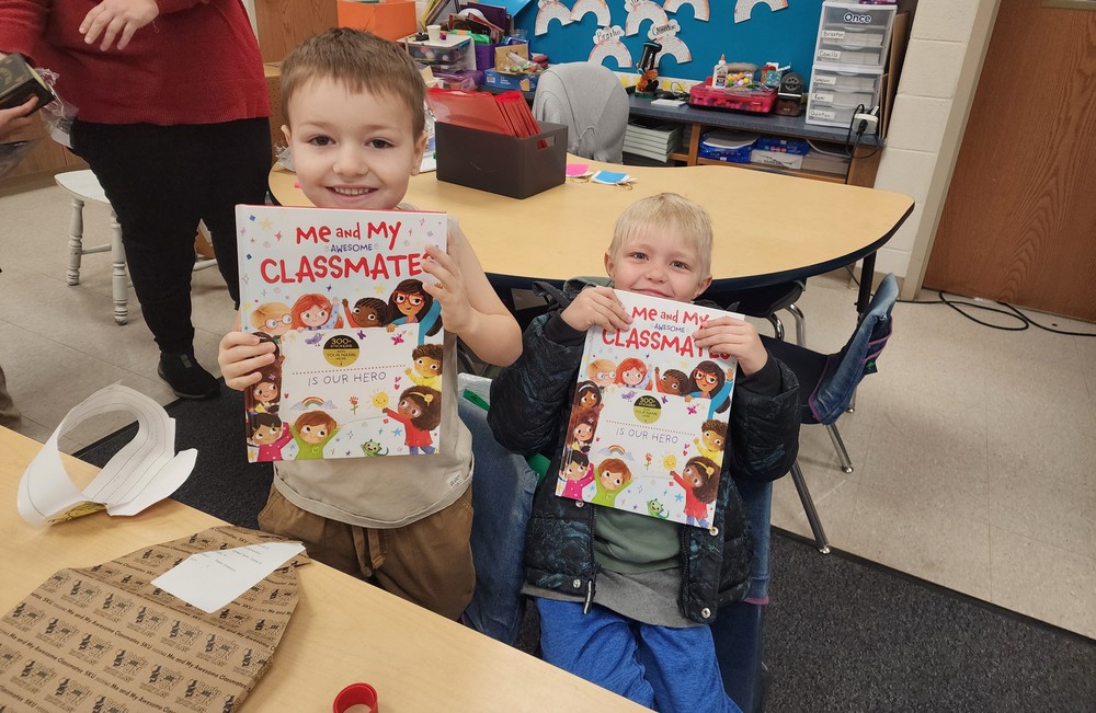 Two students holding their new books