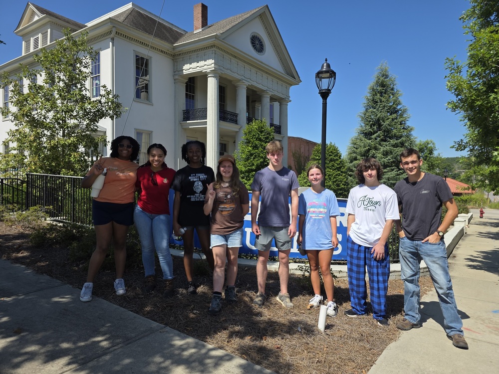 Group of students in front of house
