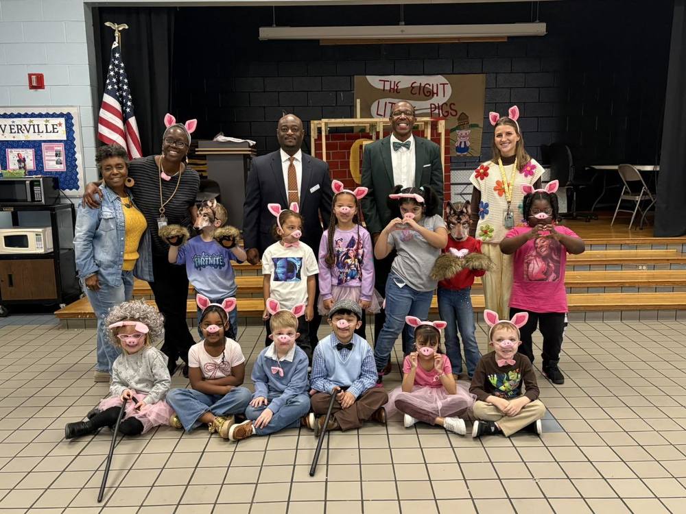 Dr. Murphy with kindergarten students  at Gloverville elementary school after the performance of a play.