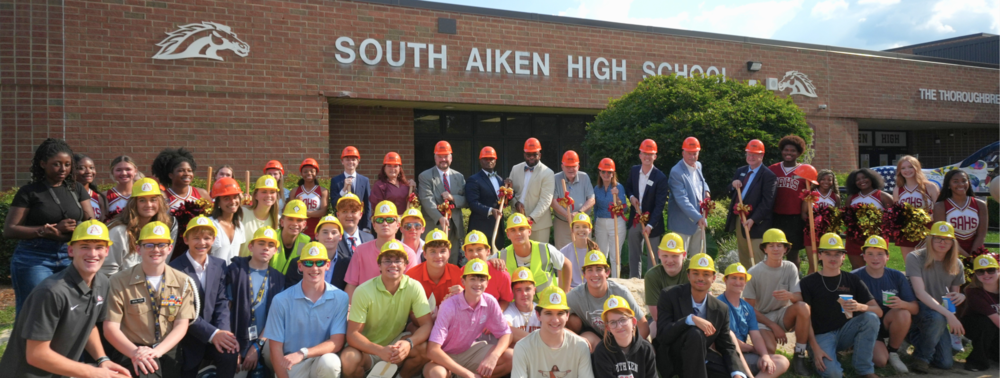 South Aiken students, alumni and community leaders pose for a groundbreaking photo.