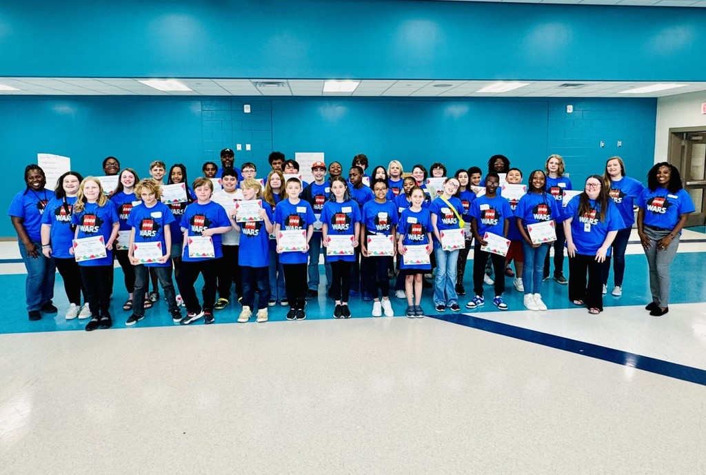 Middle School students pose for group photo in Lego Wars t-shirts.