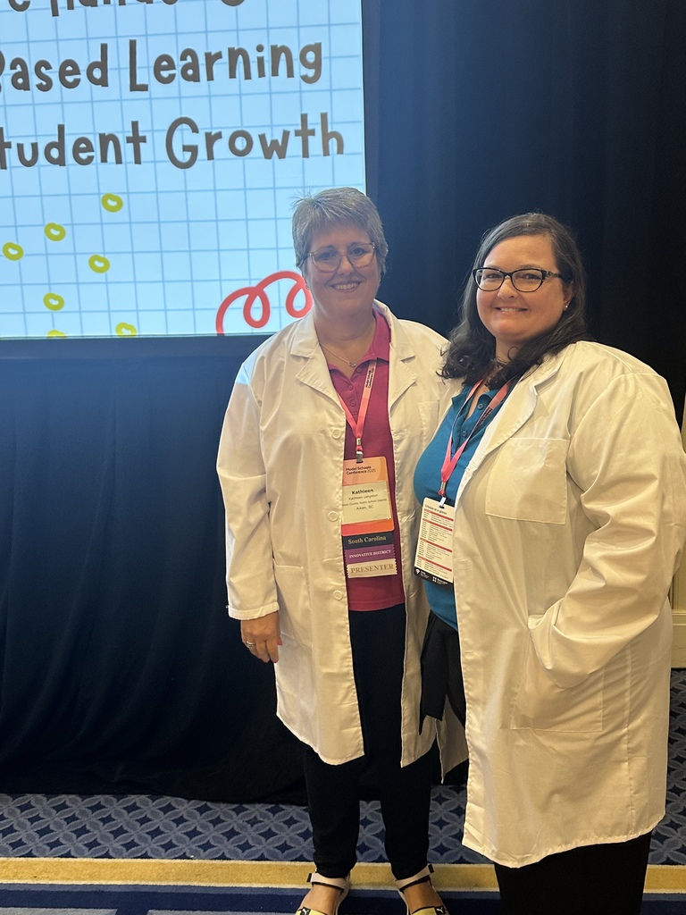 Two women wearing lab coats.
