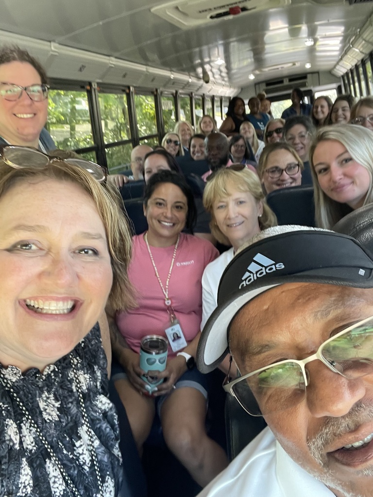 a large group of teachers inside a school bus