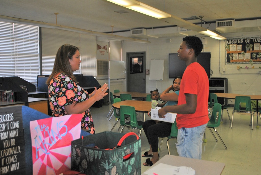 New student talking to one of his teachers for the new school year.