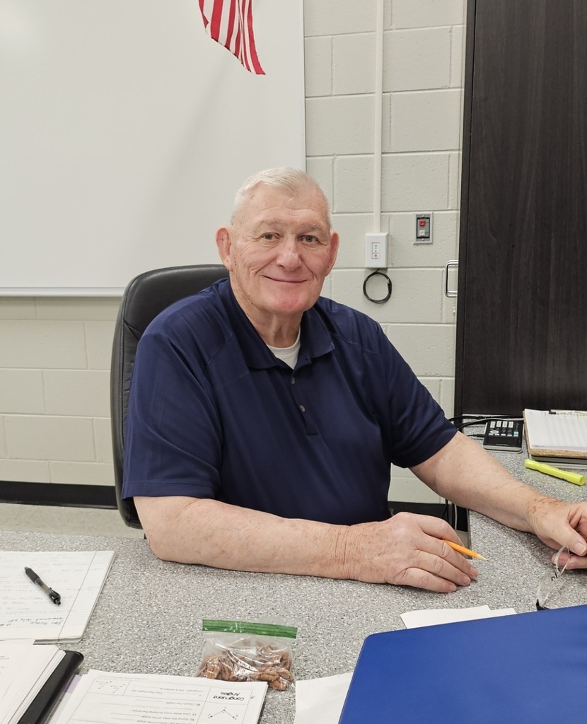 Mr. Watkins sitting at his desk. 