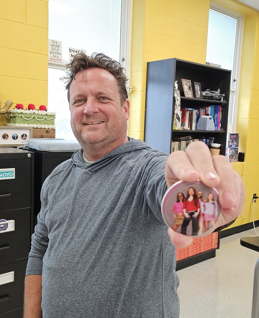 Mr. Emerling holding up a button. 