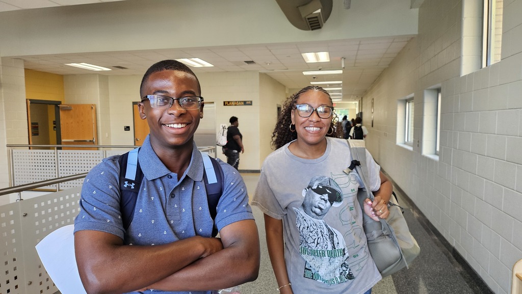 Boy and Girl smiling in hallway.