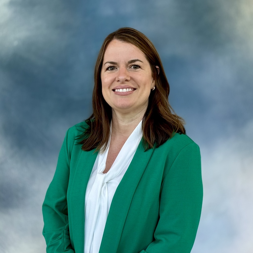 Smiling lady in a green jacket. 