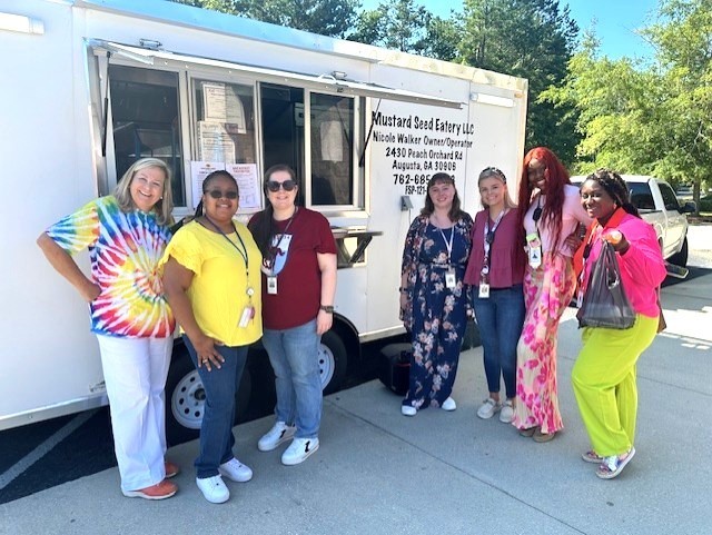 Severn ladies standing in front of a food truck
