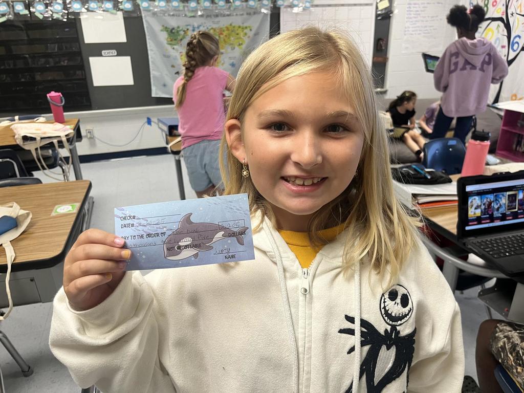 Fourth Grade Students holding "checks"