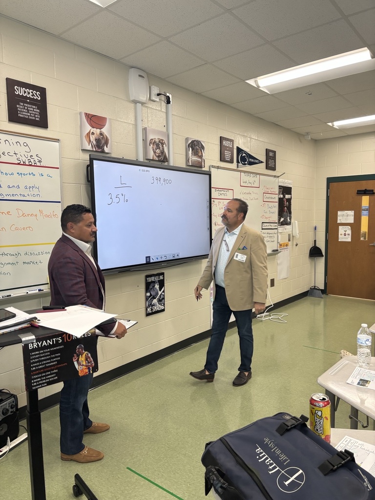 Two men in front of a whiteboard