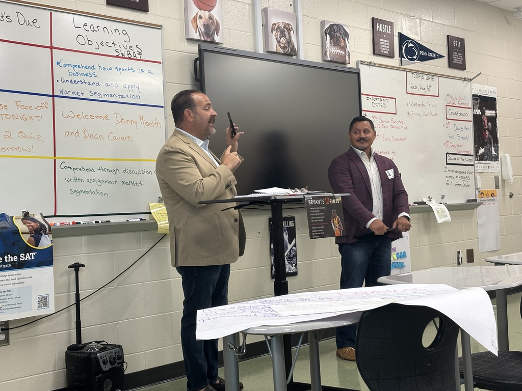 Two men talking to a class