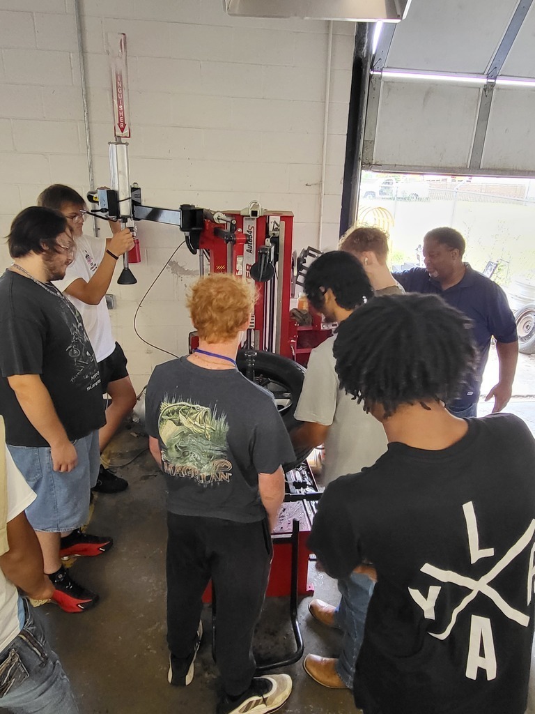 Students practice tire installation