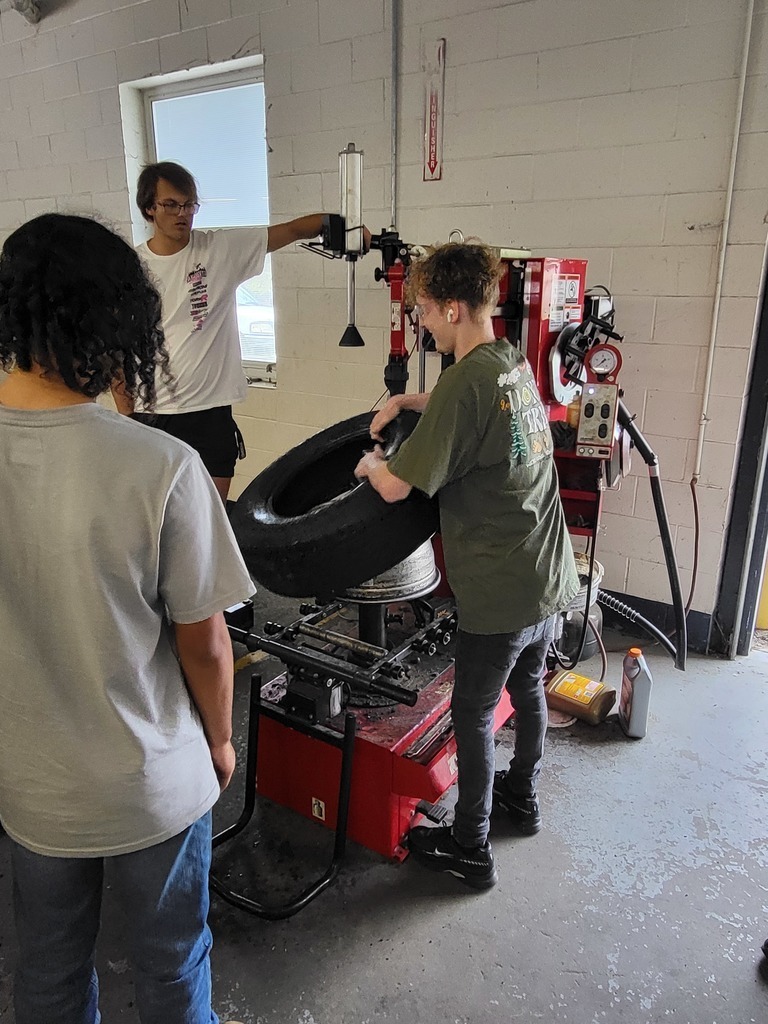 Students practice tire installation