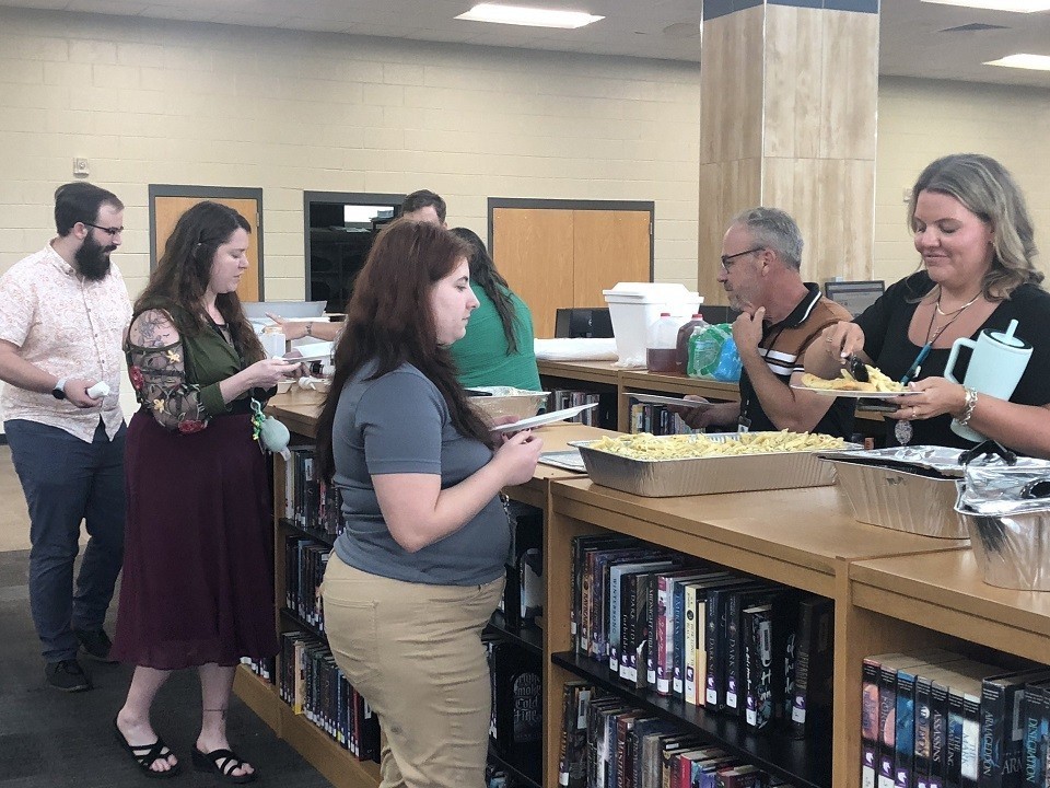 Teachers going through buffet line.