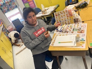 Student working on rounding to the nearest dollar