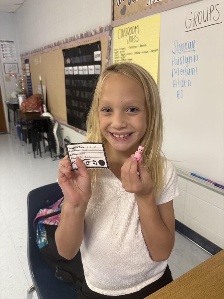 Third Grade student holding a desk pet