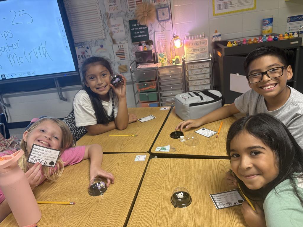 Third Grade student holding a desk pet