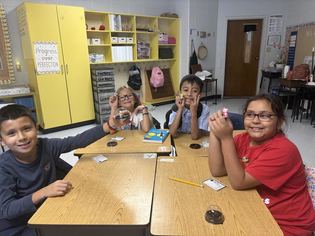 Third Grade student holding a desk pet
