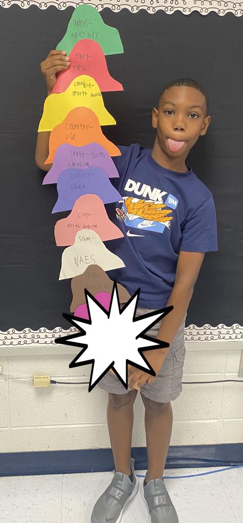 Fourth Grade student holding project