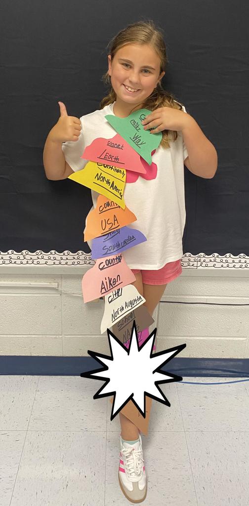 Fourth Grade student holding project