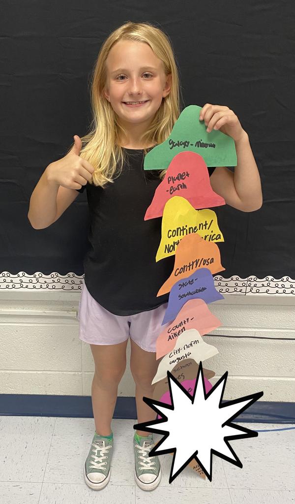 Fourth Grade student holding project