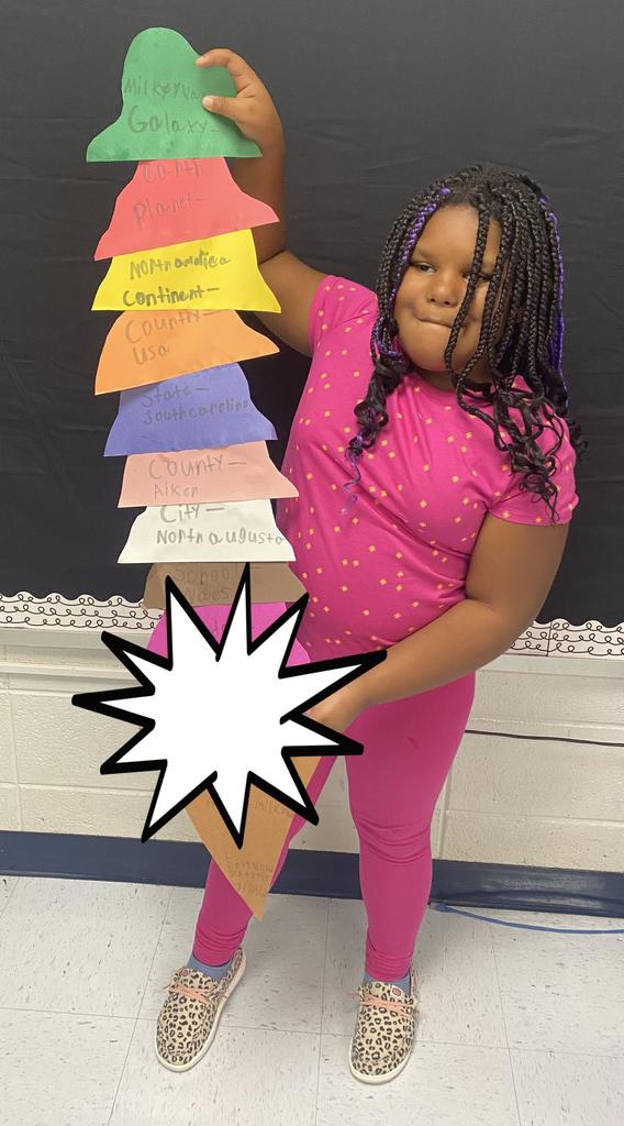 Fourth Grade student holding project