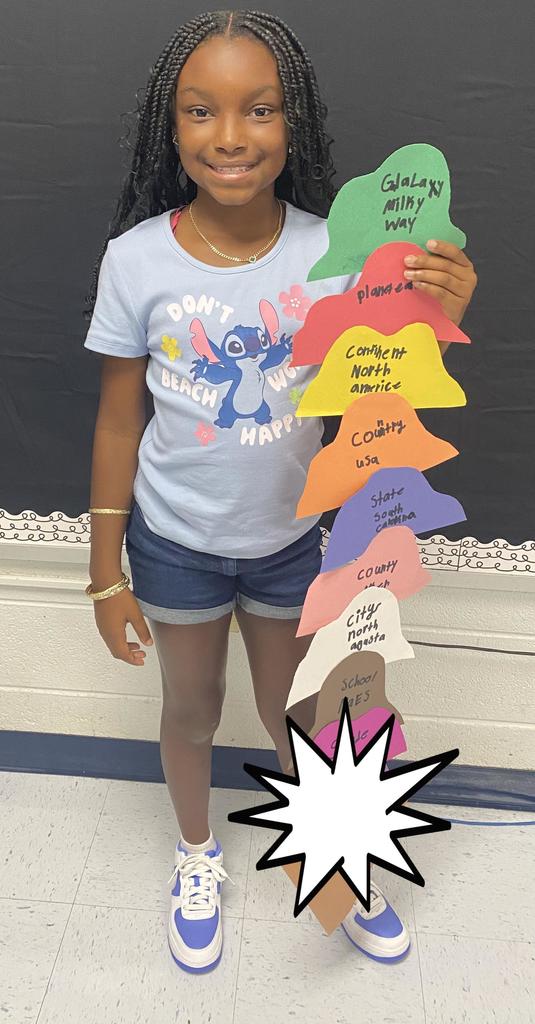 Fourth Grade student holding project