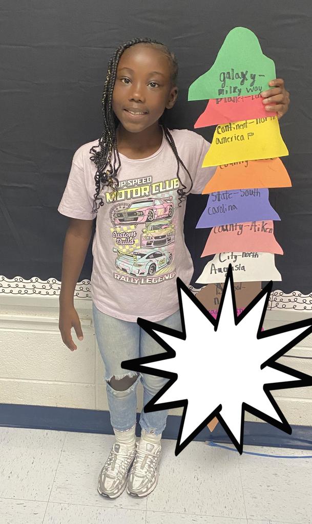 Fourth Grade student holding project