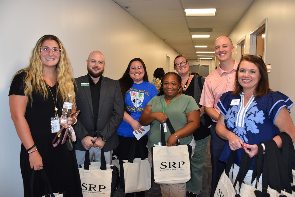 Group of people holding SRP bags.