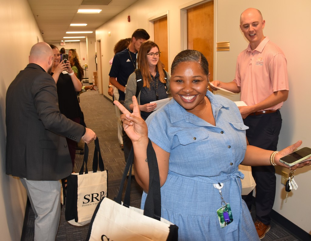 Smiling educator showing the peace sign. 